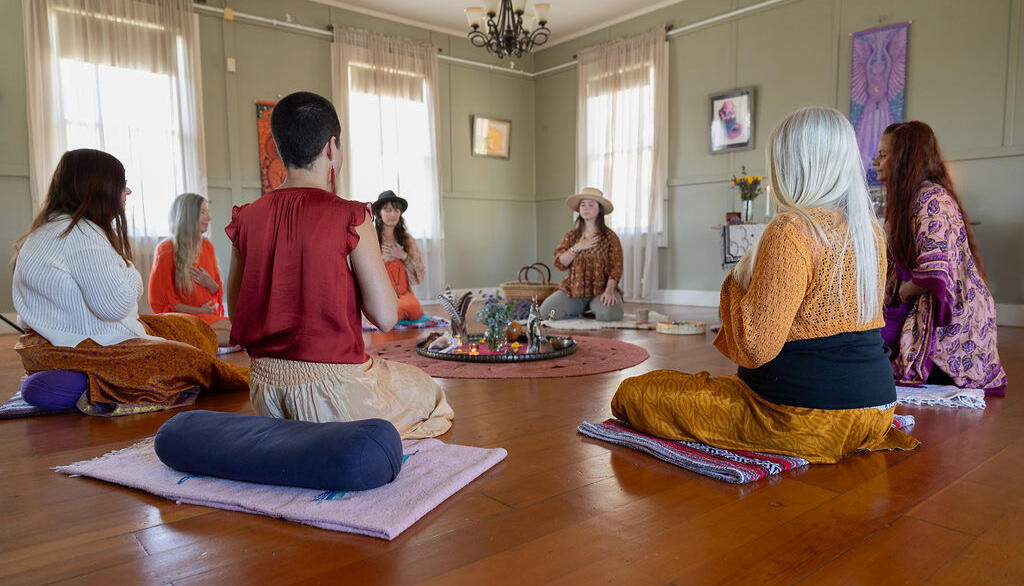 Yoga outside Man and woman seated in cross legged pose with eyes closed